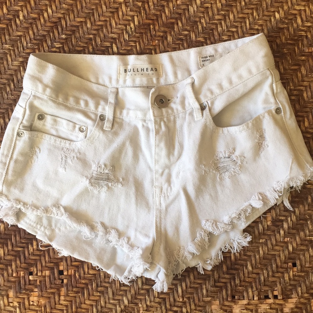 Distressed white jean shorts